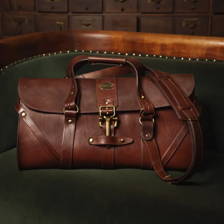 leather travel bag on green couch
