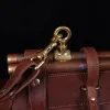 Vintage-style dark brown No. 3 Grip Bag on wooden table with a dark background - view of hook