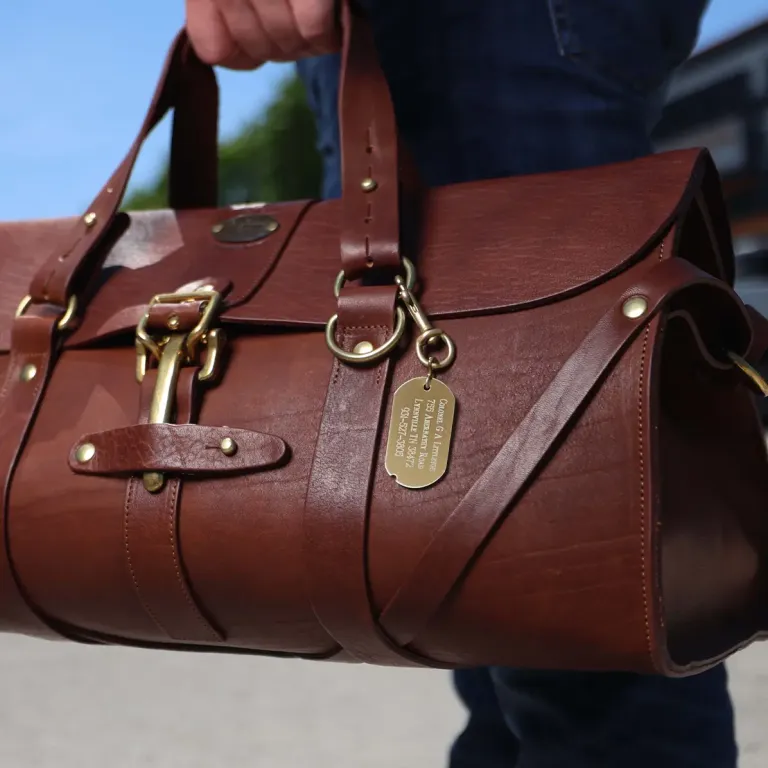 brass id luggage tag with personalization on a no 1 grip bag