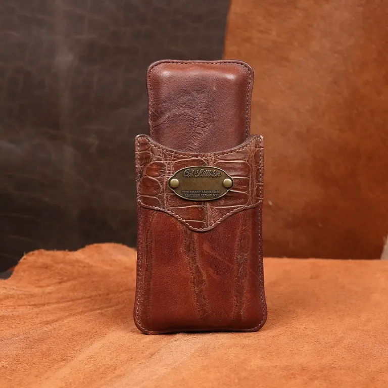 The front side of a American Steerhide and American Alligator leather cigar case with brass hardware.