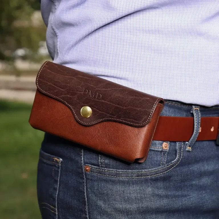 a man wearing the vintage brown and tobacco buffalo leather phone holster on his belt