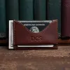 no 33 vintage brown wallet showing the front side - in front of books on wood shelf
