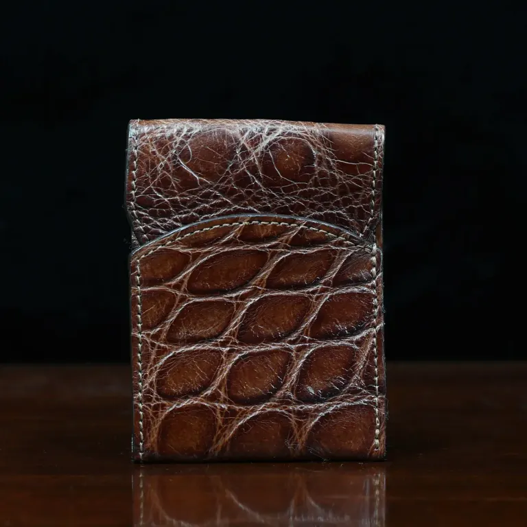 Front pocket wallet with flap in brown American Alligator - front view - 001 - on wood table with a dark background