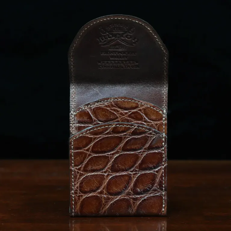 Front pocket wallet with flap in brown American Alligator - front open view - 001 - on wood table with a dark background