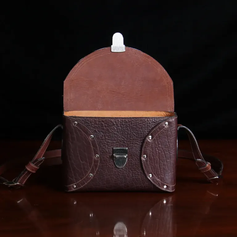 buffalo leather crossbody box bag on table - front open view