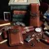 leather cigar case made in american buffalo with alligator trim with cigars, cigar cutter, watch, and books