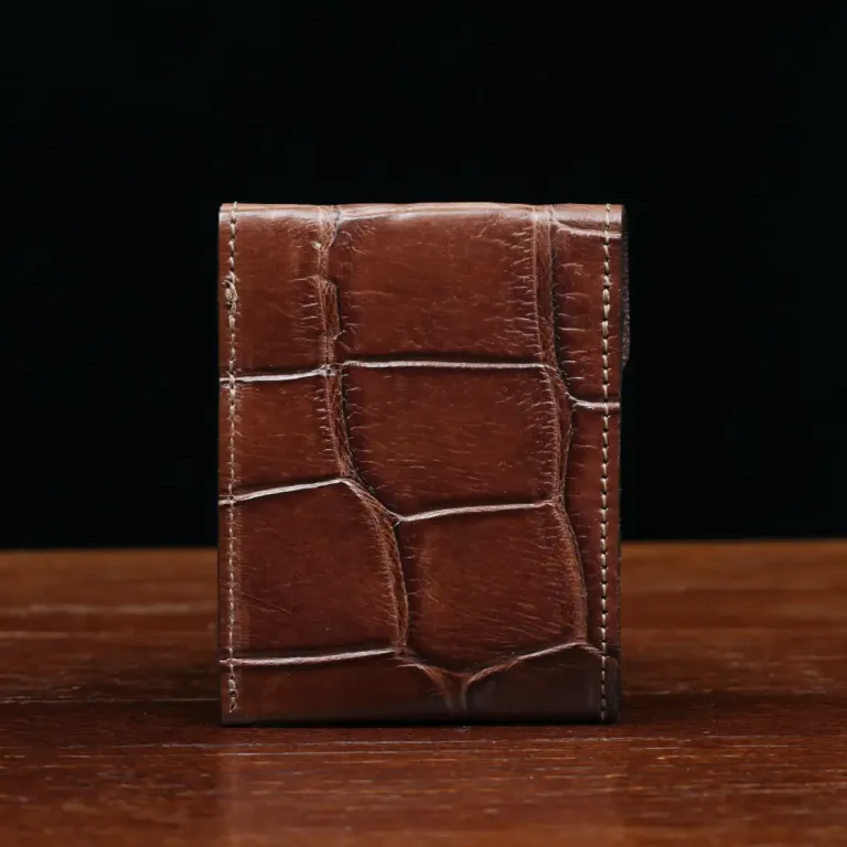 Front pocket wallet with flap in brown American Alligator - back view - 002 - on wood table with a dark background