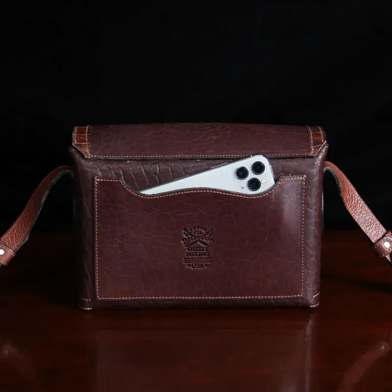buffalo leather crossbody box bag on table -back view with iphone