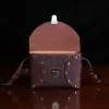 buffalo leather crossbody box bag on table - front open view