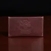 no3 card wallet in tobacco brown american buffalo - back view on wood table with dark background
