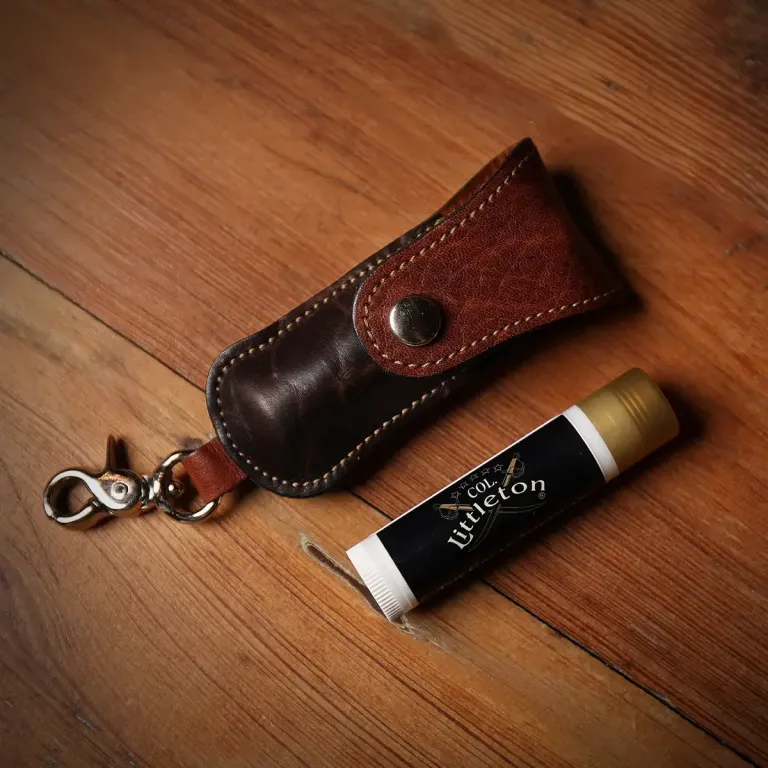 Tobacco Brown American Buffalo Lip Balm Holder with Lip Balm on wood table