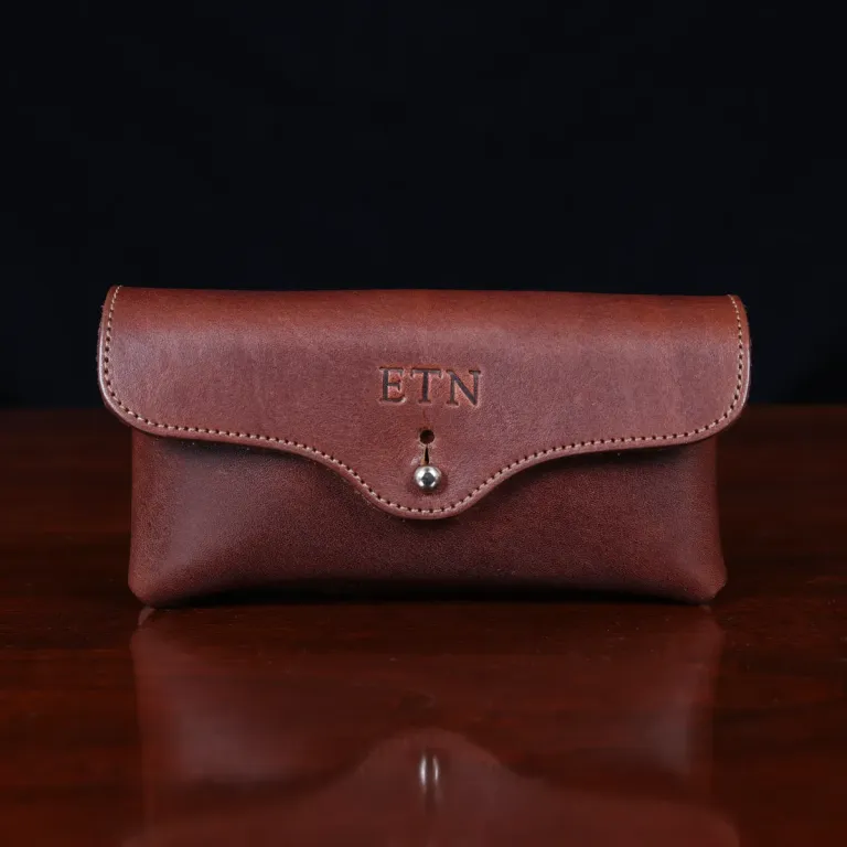 front view brown leather horizontal phone holster on a wooden table