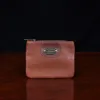 no1 brown leather small zip it bag - front view - on wooden table