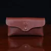 front view brown leather horizontal phone holster on a wooden table