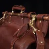Vintage-style dark brown No. 3 Grip Bag on wooden table with a dark background - view of umbrella holder