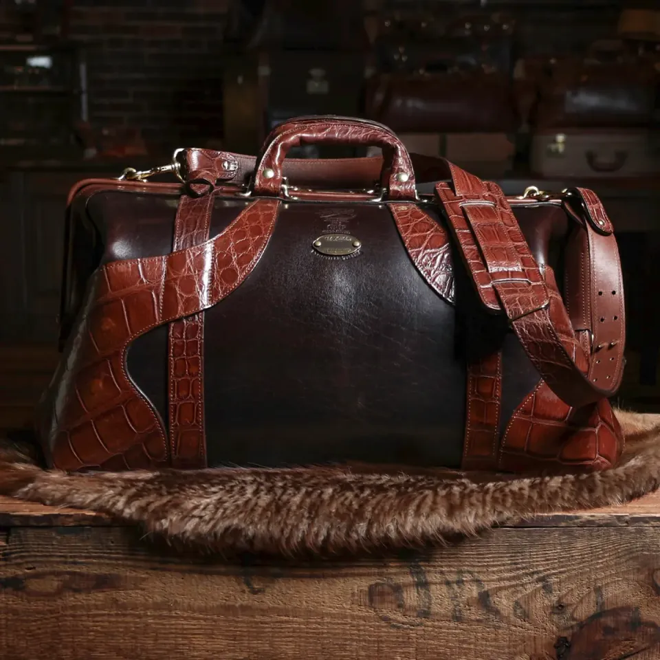 no 5 grip bag in tobacco buffalo trimmed in american alligator on a trunk