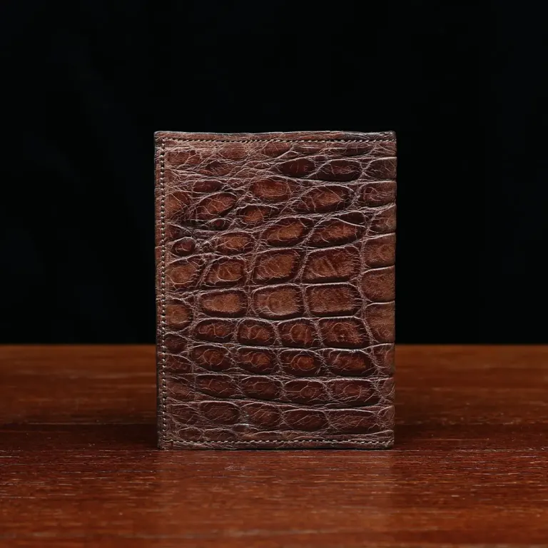 No. 2 card wallet in Vintage Brown American Alligator - ID 001 - back view on a wood table and dark background