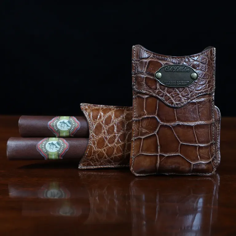 A leather Cigar Case in American Alligator showing the front with brass hardware - id 002