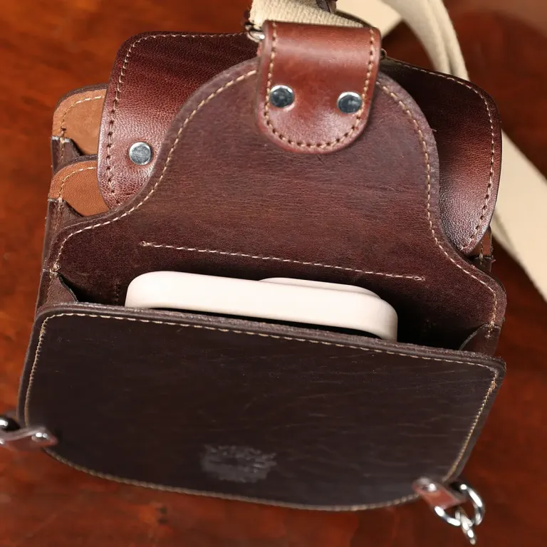 Gadabout crossbody bag - showing phone in pockets