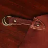 leather apron - on wooden table - view of hook