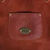 leather apron - on wooden table - view of small front pocket with personaliztion