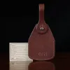 no14 leather vintage brown luggage tag with stamped personalization - on wood table and dark background