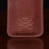 leather pencil case on wooden table - view of logo