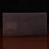leather checkbook cover back view on black background on table