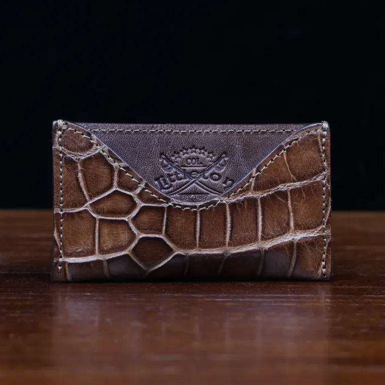 No. 3 Card Wallet in Vintage Brown American Alligator - ID 003 - front view with business card cut out on No. 2 Card Wallet in Vintage Brown American Alligator - ID 001 - front view on a black background