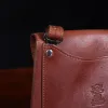 No. 22B Derby Handbag in Vintage Brown on a wood table with a dark background - detail view