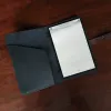 no 20 travel portfolio - in black steer hide - open with notepad
