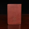 no27 vintage brown passport wallet back view with black background