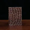 No. 2 card wallet in Vintage Brown American Alligator - ID 001 - front view on a wood table and dark background