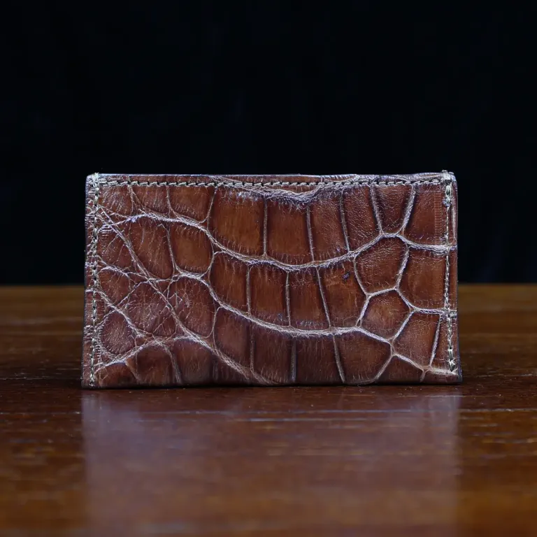 No. 3 Card Wallet in Vintage Brown American Alligator - ID 003 - front view with business card cut out on No. 2 Card Wallet in Vintage Brown American Alligator - ID 001 - back view on a black background
