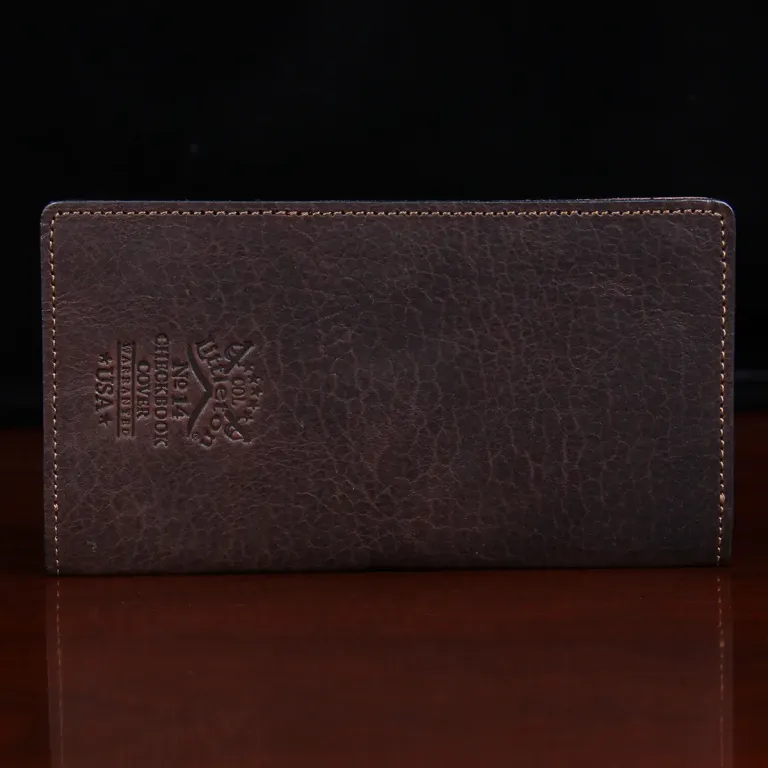 leather checkbook cover back view on black background on table