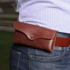 a man wearing the vintage brown leather phone holster on his belt