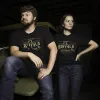 men and woman wearing the black col. littleton shirt