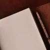 no9 brown american leather journal with notepad unruled paper on wood table with dark background