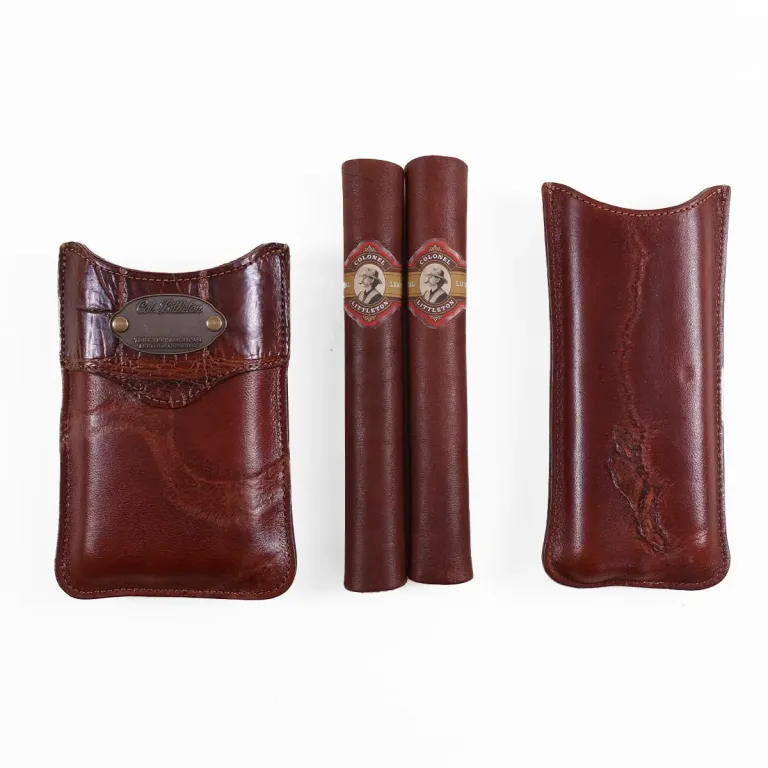 The front side of a Authentic Branded American Steerhide and American Alligator trim leather cigar case with brass hardware.