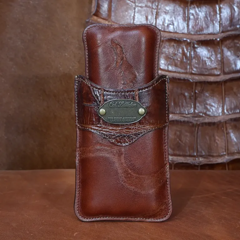 The front side of a Authentic Branded American Steerhide and American Alligator trim leather cigar case with brass hardware.