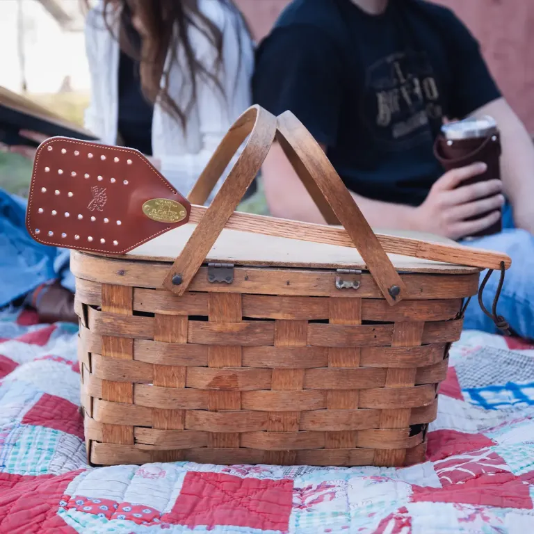 Italian Bridle Leather and American oak flyswatter propped on a picnic basket