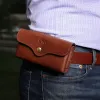 a man wearing the vintage brown leather phone holster on his belt