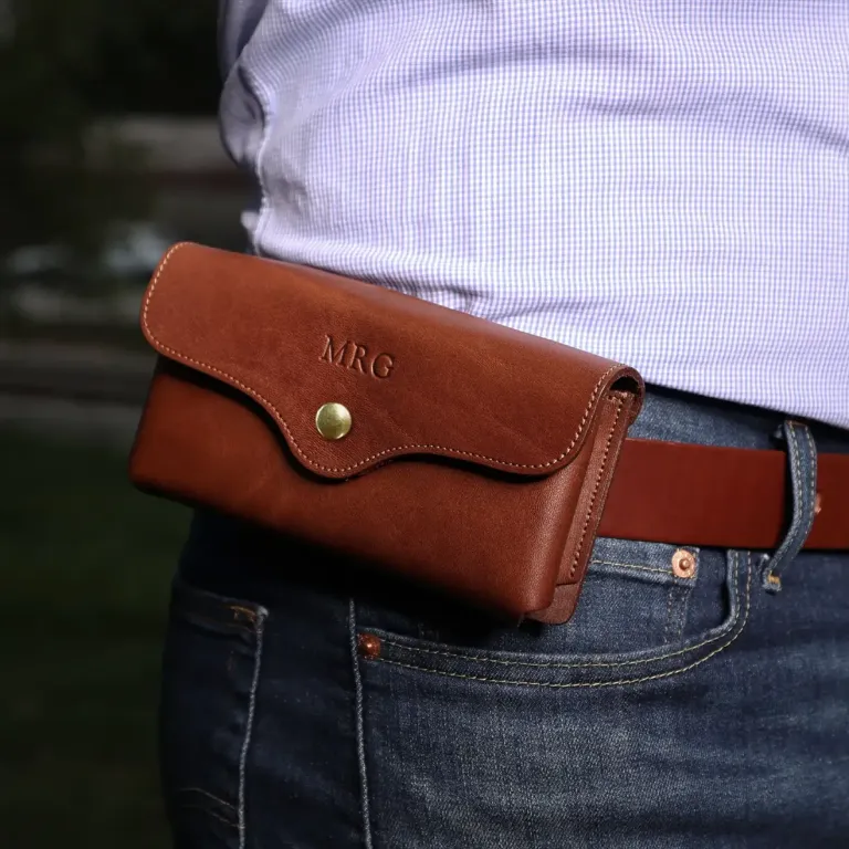 a man wearing the vintage brown leather phone holster on his belt